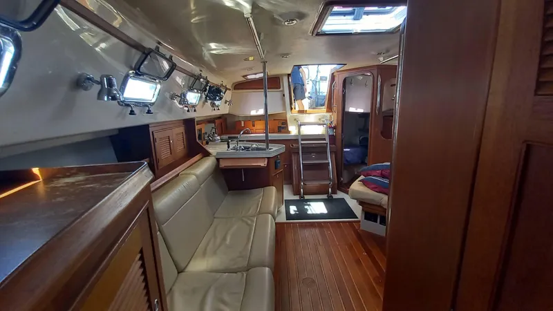Sunny Girl Yacht Photos Pics Interior of 2004 Island Packet 370 sailboat with wood finish and seating area.