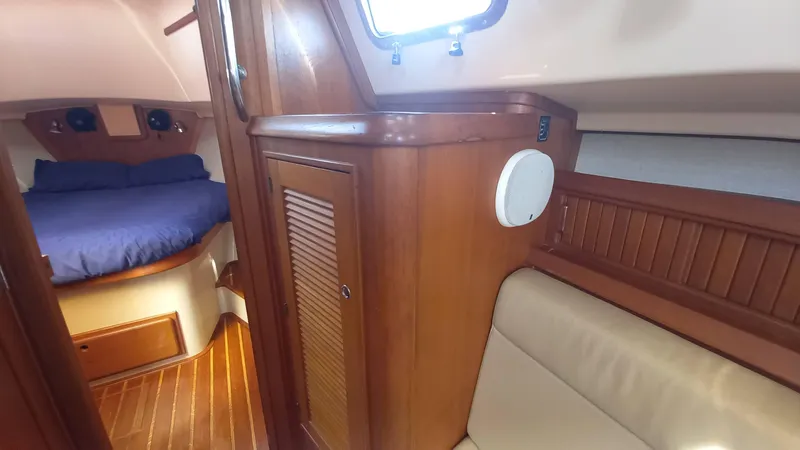 Sunny Girl Yacht Photos Pics Interior of 2004 Island Packet 370 sailboat with wood finish and cozy cabin.