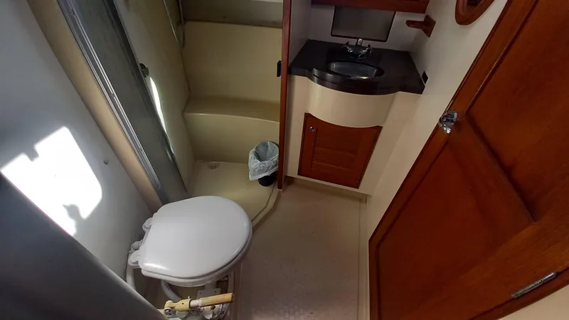 Sunny Girl Yacht Photos Pics Island Packet 370 (2004) yacht bathroom with toilet, sink, and shower area.