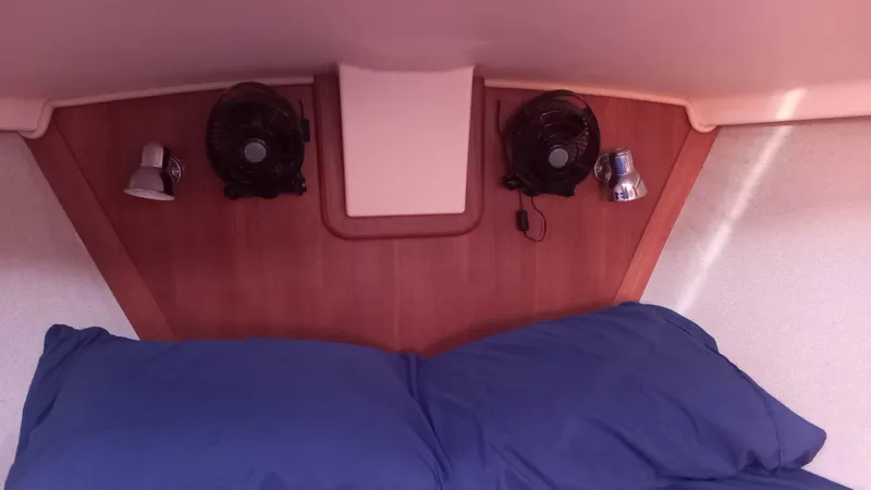Sunny Girl Yacht Photos Pics Cozy cabin interior of 2004 Island Packet 370 sailboat with blue bedding and dual fans.