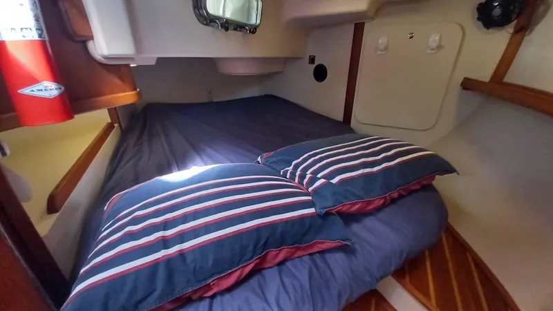 Sunny Girl Yacht Photos Pics Cozy cabin interior of 2004 Island Packet 370 sailboat with striped bedding.