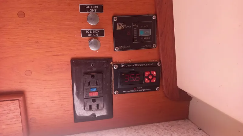 Sunny Girl Yacht Photos Pics Control panel on 2004 Island Packet 370 sailboat with electrical outlets and climate control.