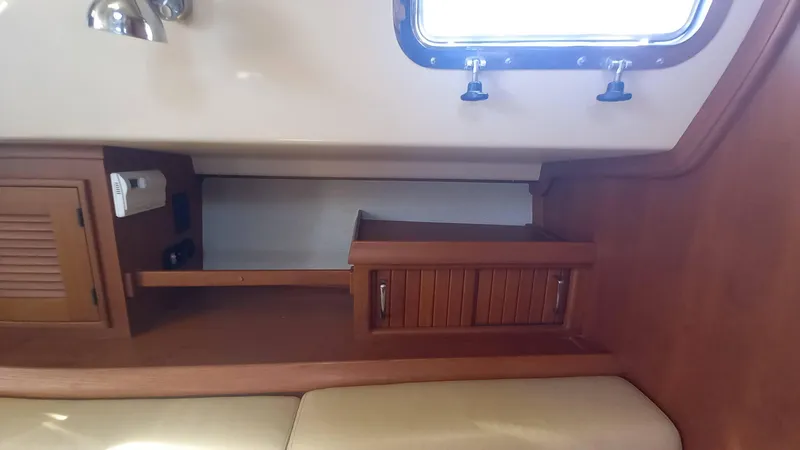 Sunny Girl Yacht Photos Pics Interior cabin of 2004 Island Packet 370 sailboat with wooden storage and window.