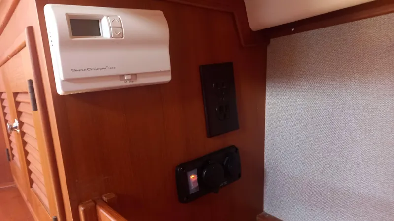 Sunny Girl Yacht Photos Pics Interior of 2004 Island Packet 370 yacht with thermostat and electrical panel.