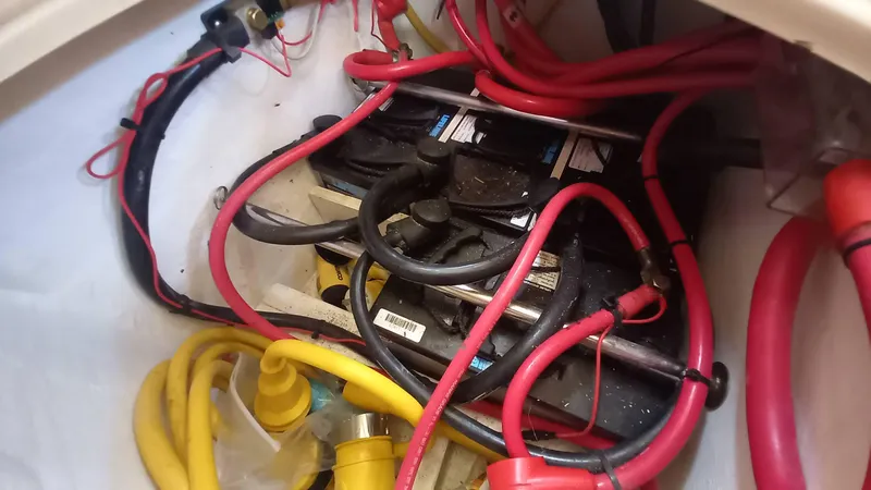 Sunny Girl Yacht Photos Pics Battery compartment of a 2004 Island Packet 370 sailboat with red and yellow cables.