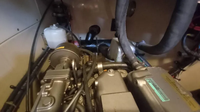 Sunny Girl Yacht Photos Pics Engine compartment of a 2004 Island Packet 370 sailboat, showing hoses and components.
