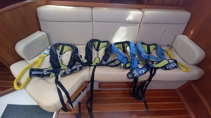 Sunny Girl Yacht Photos Pics Life jackets on a beige sofa inside a 2004 Island Packet 370 yacht.