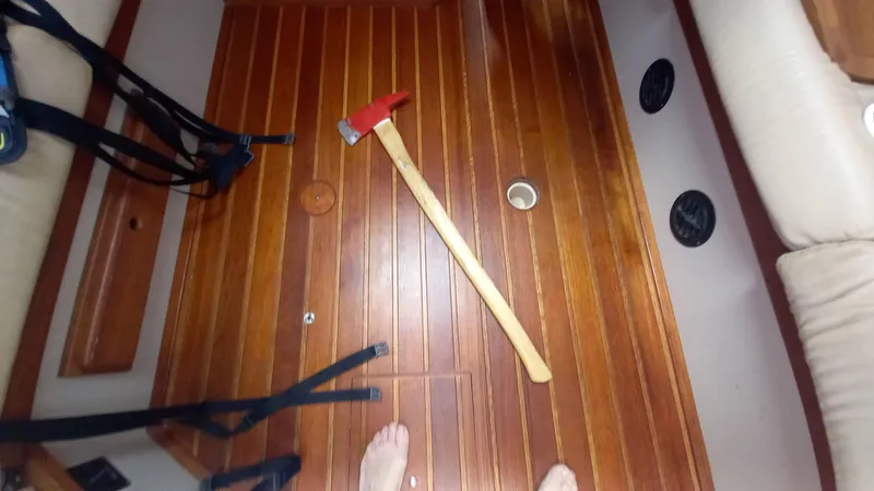 Sunny Girl Yacht Photos Pics Wooden boat interior with an axe on the floor, Island Packet 370, 2004 model.