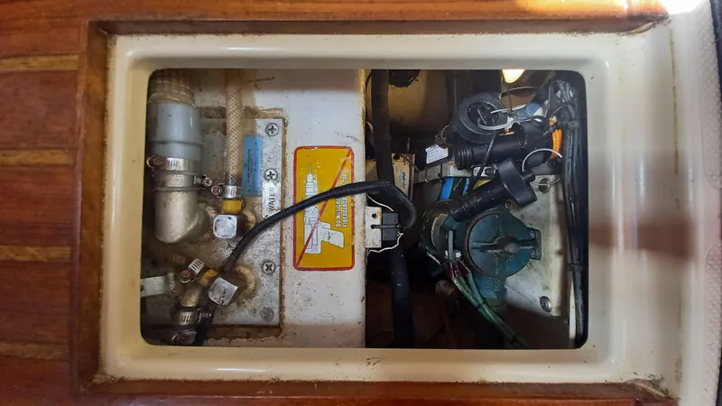 Sunny Girl Yacht Photos Pics Engine compartment of a 2004 Island Packet 370 sailboat, showing mechanical components and wiring.