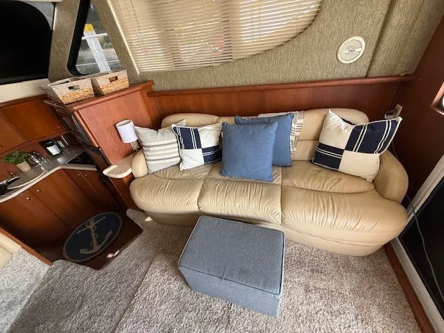  Yacht Photos Pics Interior of 2004 Silverton 34 Convertible with beige sofa and nautical-themed decor.