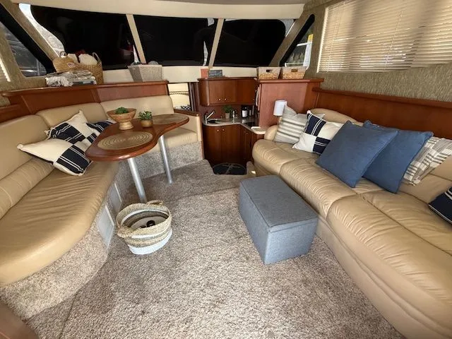  Yacht Photos Pics Interior of 2004 Silverton 34 Convertible yacht with beige seating and decorative pillows.