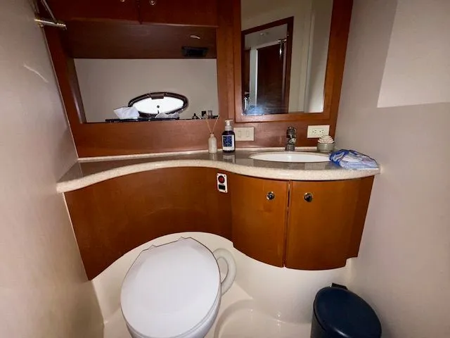 Yacht Photos Pics 2004 Silverton 34 Convertible yacht bathroom with wooden cabinetry and modern fixtures.