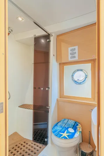  Yacht Photos Pics Bathroom interior of 2011 Beneteau Monte Carlo 47 Fly yacht, featuring shower and nautical decor.