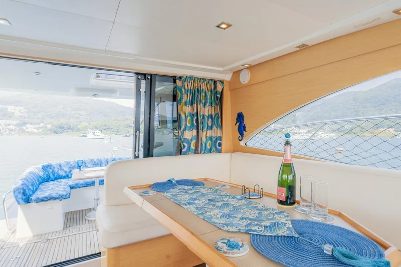  Yacht Photos Pics Interior of 2011 Beneteau Monte Carlo 47 Fly yacht with elegant dining area and scenic view.