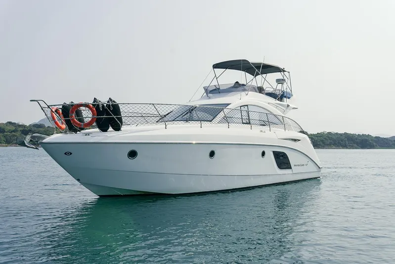  Yacht Photos Pics 2011 Beneteau Monte Carlo 47 Fly yacht on calm water, showcasing sleek design and luxury features.