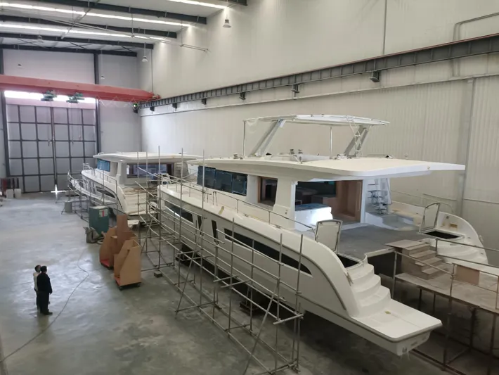  Yacht Photos Pics 2025 Mazarin 55 Catamaran Hybrid Electric EVO II in a shipyard.