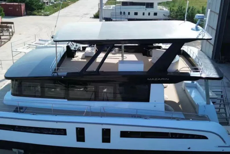  Yacht Photos Pics 2025 Mazarin 55 Catamaran Hybrid Electric EVO II docked, showcasing sleek design and modern features.