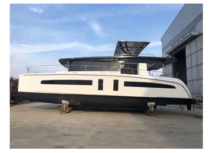  Yacht Photos Pics 2025 Mazarin 55 Catamaran Hybrid Electric EVO II docked at a shipyard.