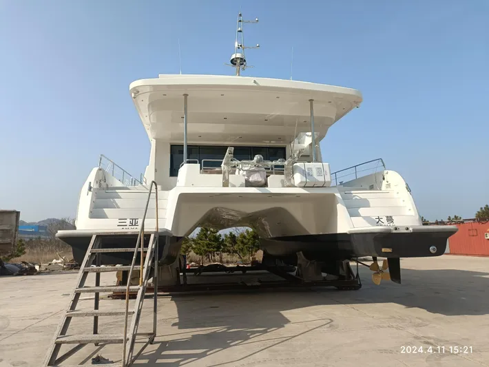  Yacht Photos Pics 2025 Mazarin 55 Catamaran Hybrid Electric EVO II on dry dock with ladder access.