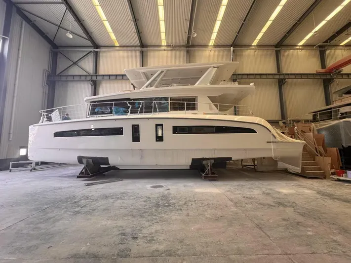  Yacht Photos Pics 2025 Mazarin 55 Catamaran Hybrid Electric EVO II in a spacious indoor facility.