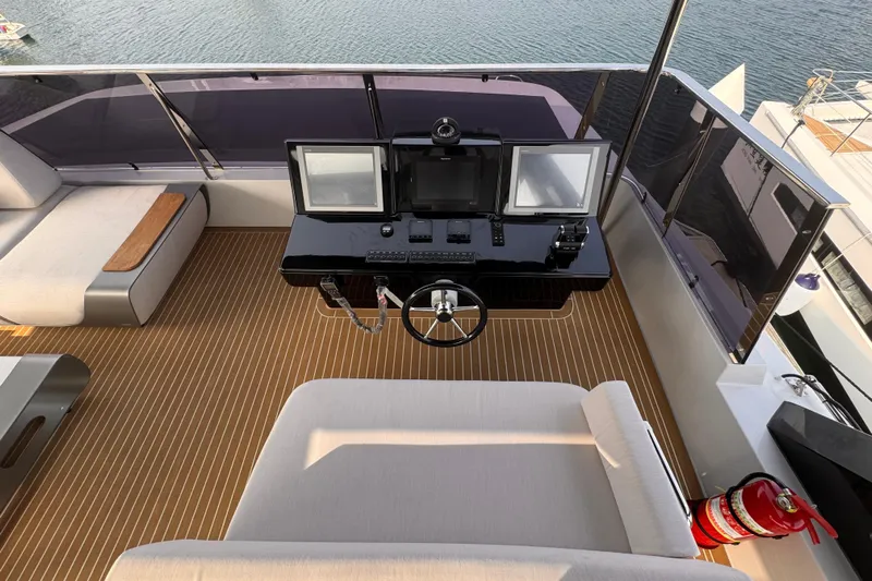  Yacht Photos Pics Helm of 2025 Mazarin 55 Catamaran Hybrid Electric EVO II with modern controls and seating.