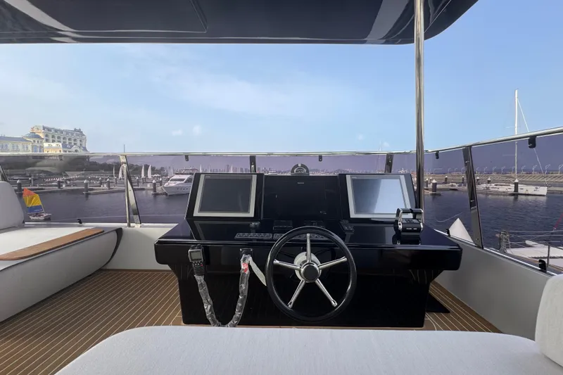  Yacht Photos Pics Helm of 2025 Mazarin 55 Catamaran Hybrid Electric EVO II overlooking marina.