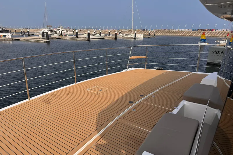  Yacht Photos Pics Deck view of 2025 Mazarin 55 Catamaran Hybrid Electric EVO II in marina.