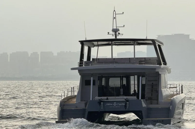  Yacht Photos Pics Mazarin 55 Catamaran Hybrid Electric EVO II sailing on a misty waterway, 2025 model.