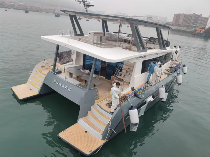  Yacht Photos Pics 2025 Mazarin 55 Catamaran Hybrid Electric EVO II docked with crew onboard.