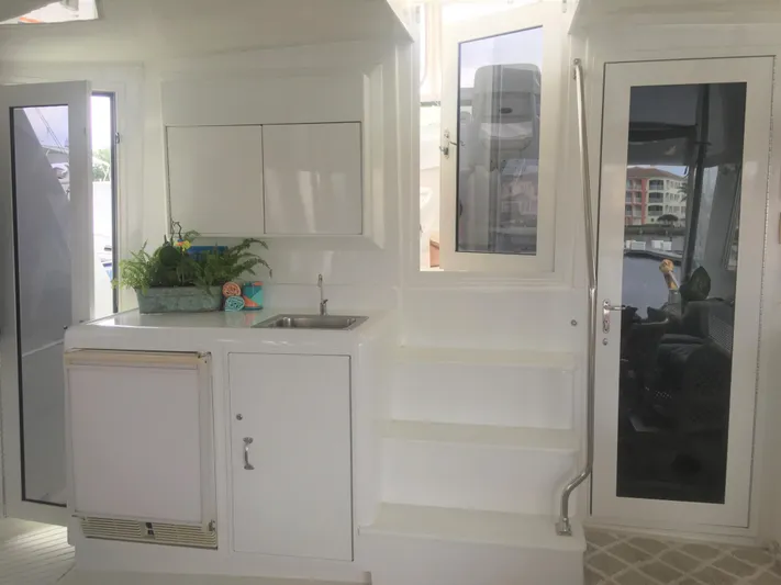 Tropic Jones Yacht Photos Pics Interior of 1997 Hatteras 52 Cockpit Motor Yacht with kitchenette and stairs.