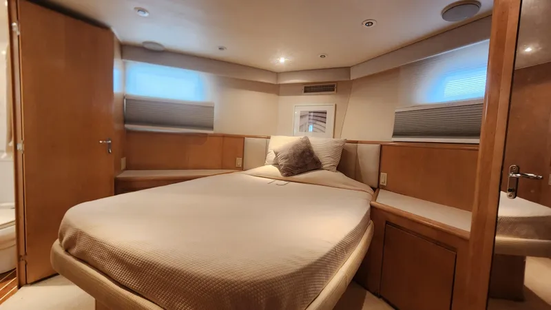 Tropic Jones Yacht Photos Pics Luxurious bedroom interior of a 1997 Hatteras 52 Cockpit Motor Yacht with cozy bedding.
