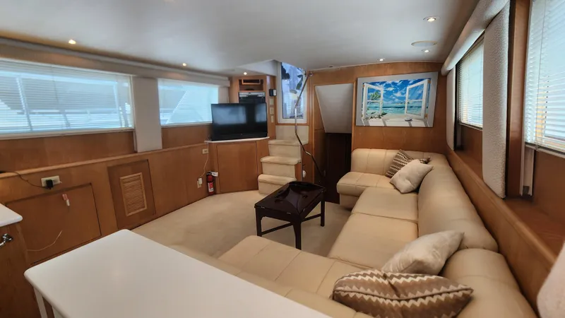 Tropic Jones Yacht Photos Pics Luxurious interior of 1997 Hatteras 52 Cockpit Motor Yacht with plush seating and modern decor.