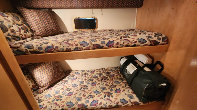 Tropic Jones Yacht Photos Pics Bunk beds in 1997 Hatteras 52 Cockpit Motor Yacht cabin with patterned bedding.