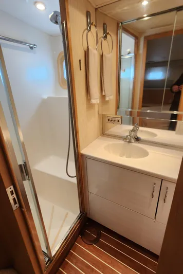 Tropic Jones Yacht Photos Pics Bathroom interior of 1997 Hatteras 52 Cockpit Motor Yacht with shower and vanity.