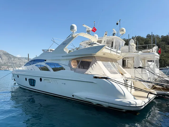 Nvn Yacht Photos Pics 2007 Azimut 62 yacht docked in a scenic marina with clear blue skies.