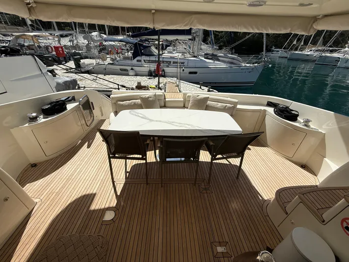 Nvn Yacht Photos Pics Luxurious 2007 Azimut 62 yacht deck with dining area, docked at marina.