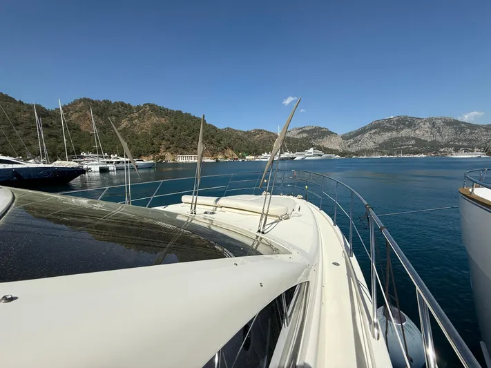 Nvn Yacht Photos Pics 2007 Azimut 62 yacht docked in scenic marina with mountainous backdrop.