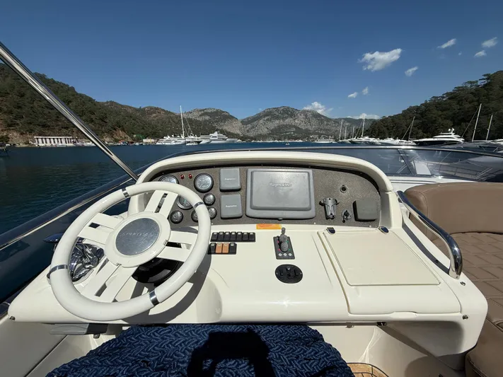 Nvn Yacht Photos Pics Helm of 2007 Azimut 62 yacht with scenic mountain and marina view.