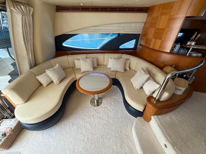 Nvn Yacht Photos Pics Luxurious interior of a 2007 Azimut 62 yacht with elegant curved seating and a round table.