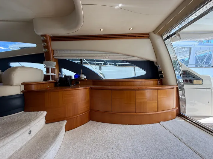 Nvn Yacht Photos Pics Luxurious interior of a 2007 Azimut 62 yacht with elegant wood cabinetry and plush seating.