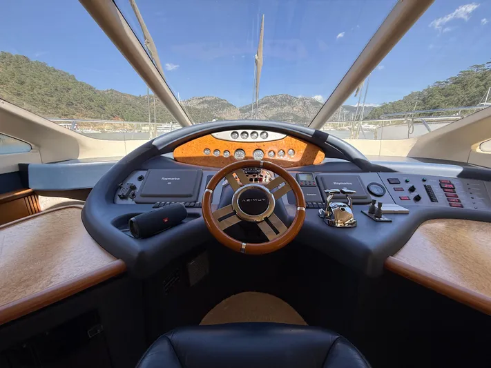 Nvn Yacht Photos Pics Cockpit view of a 2007 Azimut 62 yacht with scenic mountain backdrop.