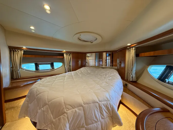 Nvn Yacht Photos Pics Luxurious bedroom interior of a 2007 Azimut 62 yacht with elegant wood finishes.