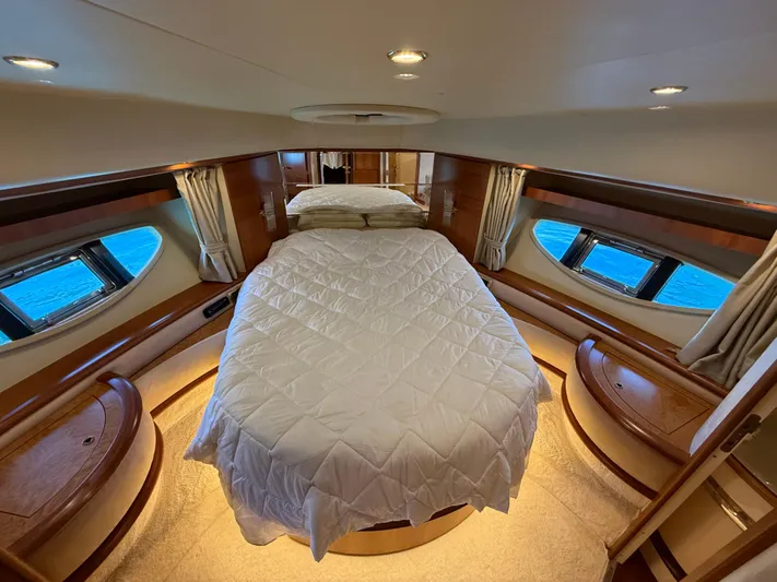 Nvn Yacht Photos Pics Luxurious bedroom interior of a 2007 Azimut 62 yacht with elegant wood finishes.