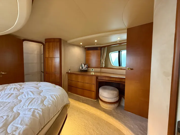 Nvn Yacht Photos Pics Luxurious interior of a 2007 Azimut 62 yacht, featuring elegant wood finishes and plush bedding.