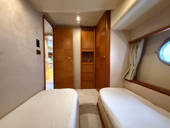 Nvn Yacht Photos Pics Interior of 2007 Azimut 62 yacht with twin beds and wooden cabinetry.