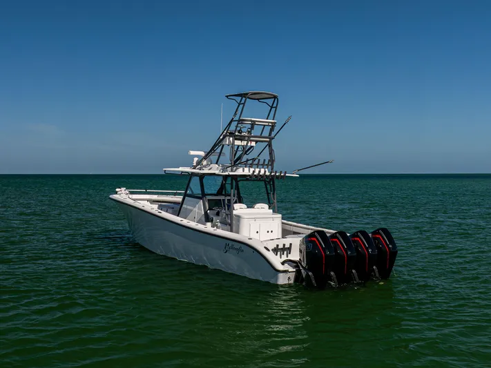  Yacht Photos Pics 2023 Yellowfin 39 Offshore boat with multiple engines on calm sea.