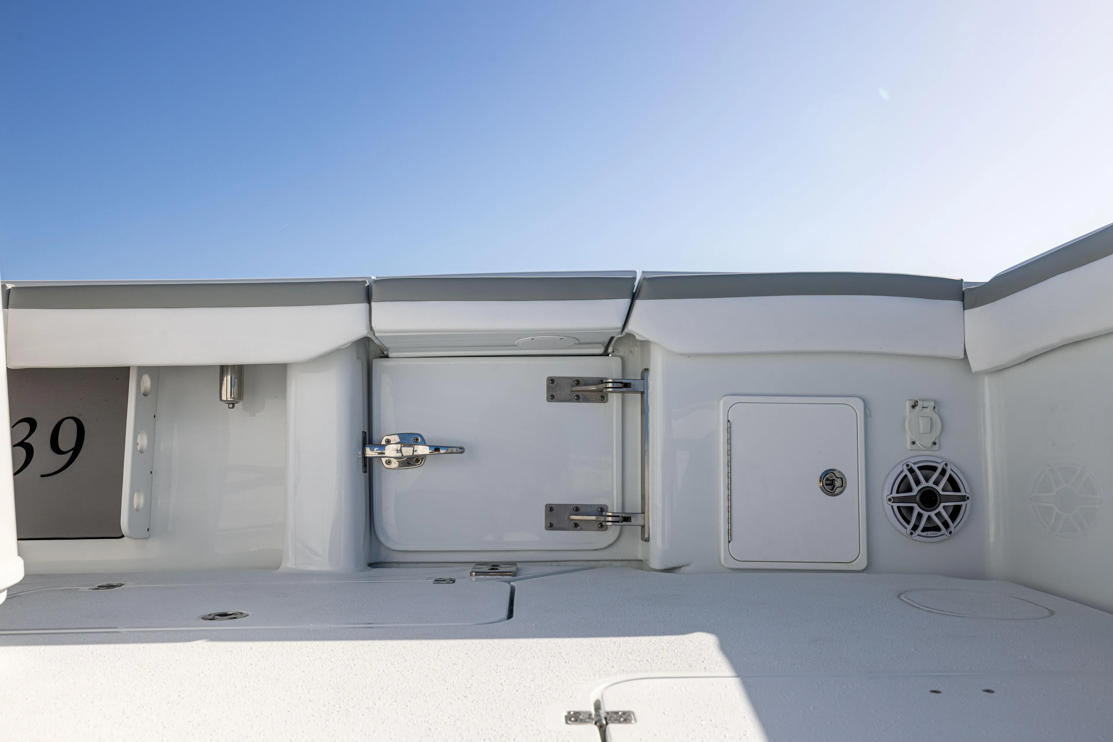  Yacht Photos Pics 2023 Yellowfin 39 Offshore boat interior with storage compartments and speaker.