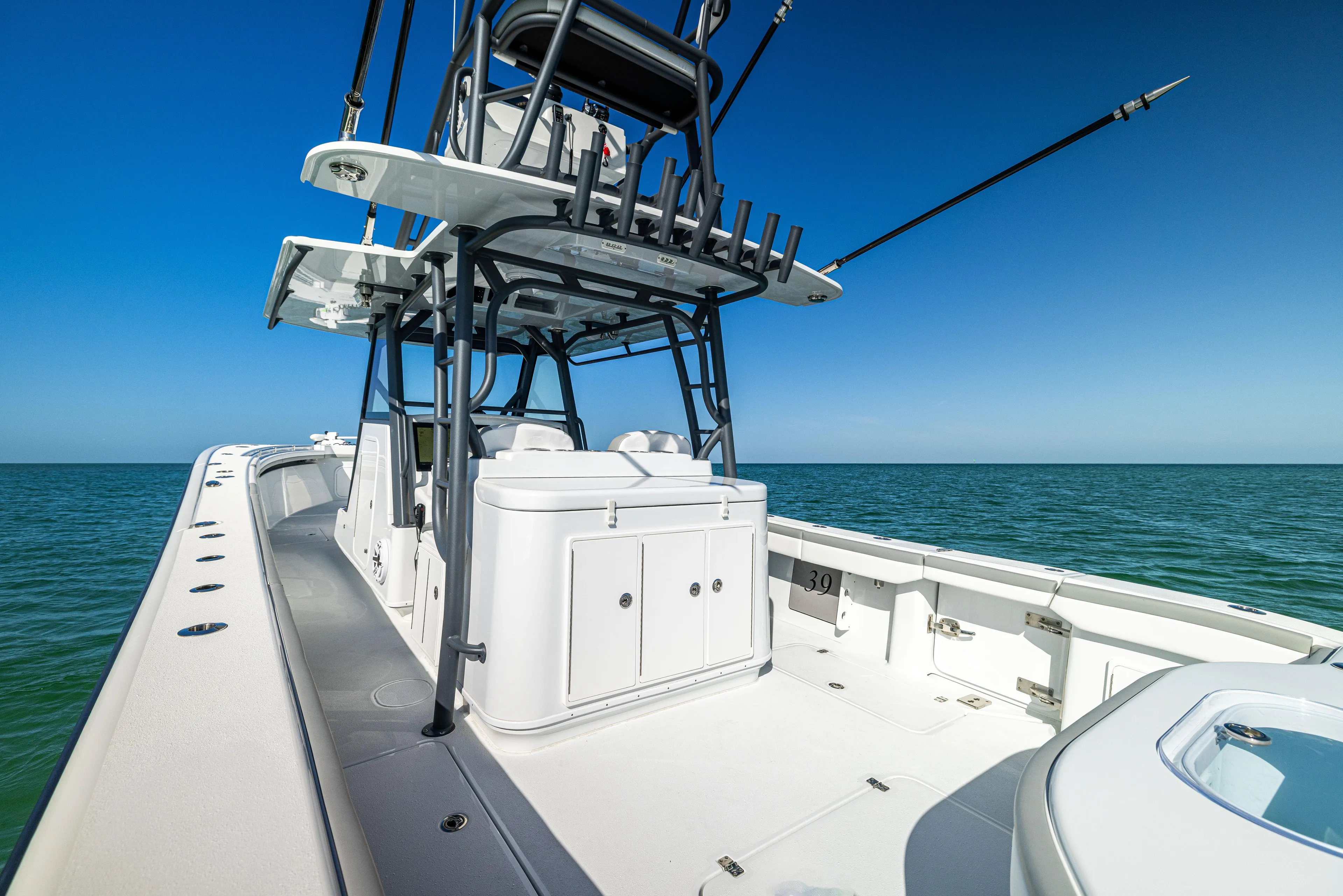  Yacht Photos Pics 2023 Yellowfin 39 Offshore boat on open water, showcasing spacious deck and seating.