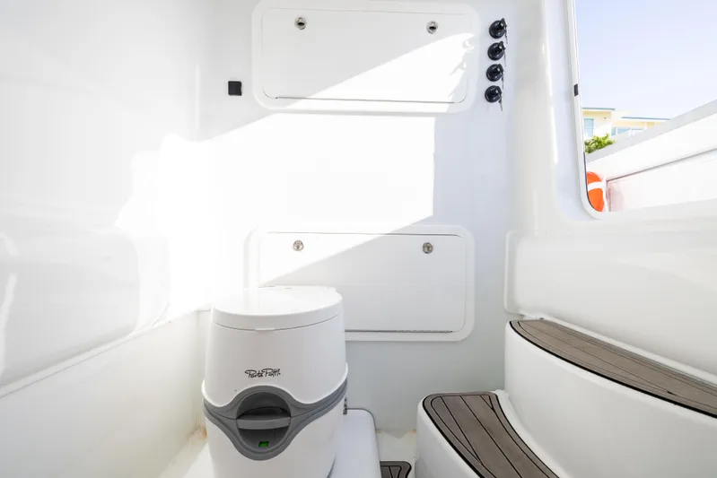  Yacht Photos Pics 2023 Yellowfin 39 Offshore boat interior with compact toilet and storage compartments.