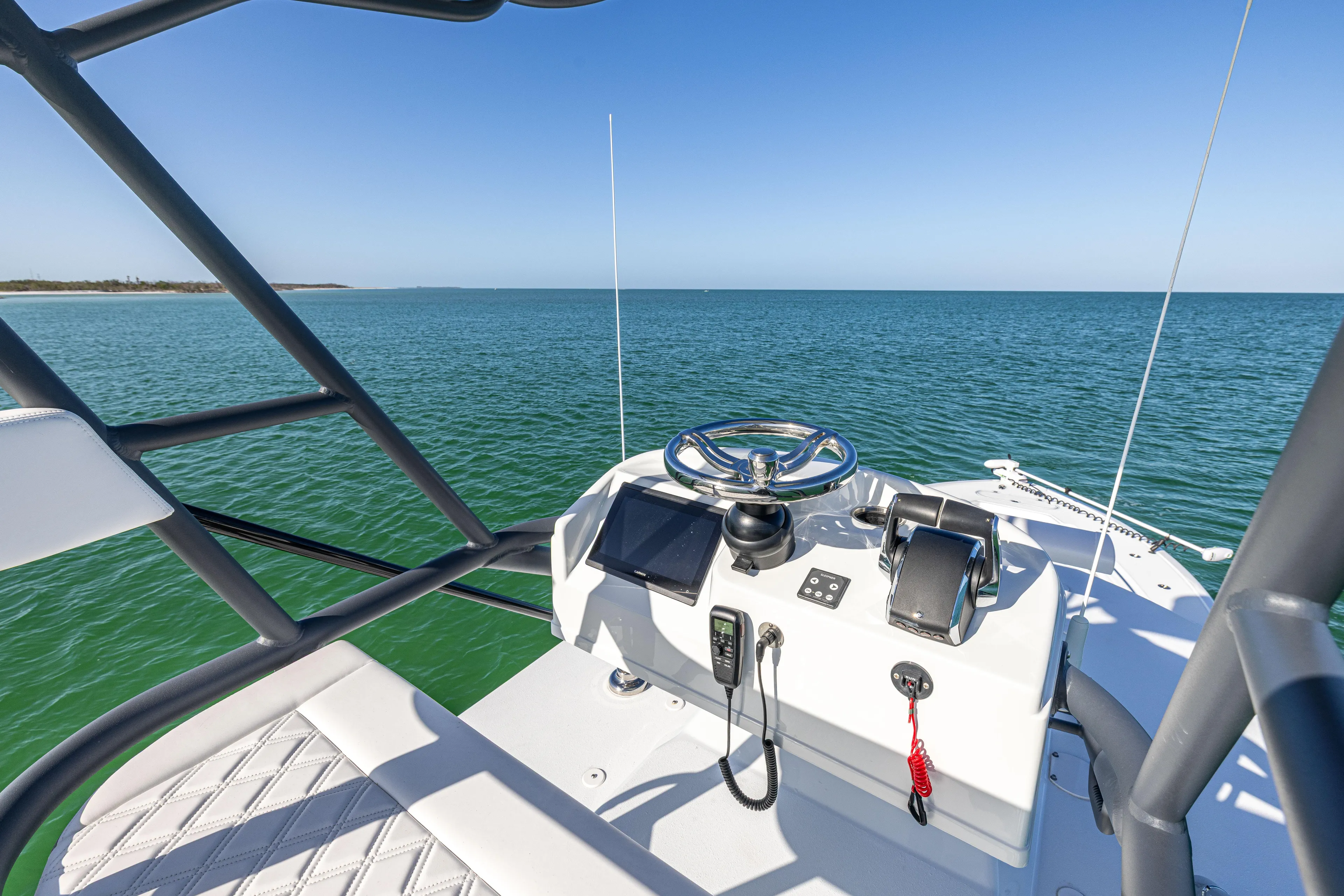  Yacht Photos Pics 2023 Yellowfin 39 Offshore boat helm with ocean view, featuring modern controls and steering.